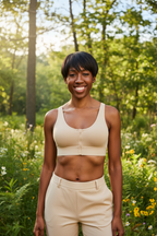 Woman wearing beige front-closure cotton bralette in a nature setting