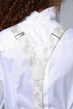Elegant chalk white floral patterned silk suspenders in editorial product shot